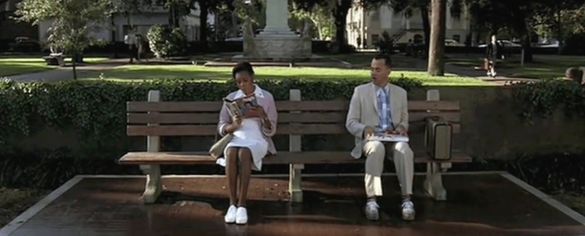 Scene from Forrest Gump, Forrest Gump sitting on chair and asking strangers about chocolates.
