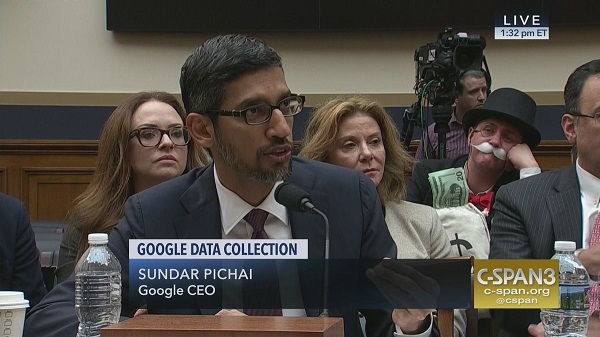 Monopoly guy sitting behind Sundar Pichai.