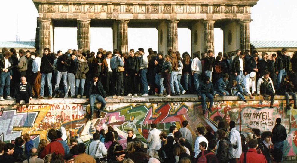 People gathering in front of the Berlin Wall