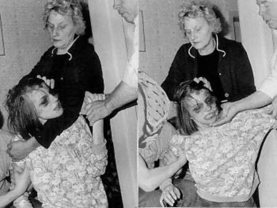 Anneliese being held by her mother during her exorcism 
